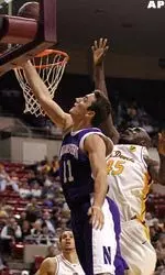 Northwestern forward Vedran Vukusic scores two points in front of Arizona State's Serge Angounou during the first half.(AP Photo/Roy Dabner)
