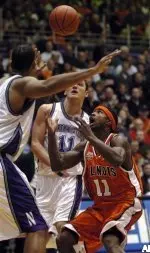 Dee Brown loses control of the basketball as he heads to the basket against NU defenders Vedran Vukusic and Mike Thompson.