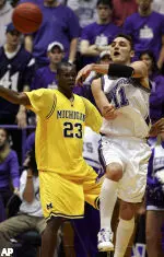 Vedran Vukusic makes a pass against Michigan's Brent Petway during the first half.