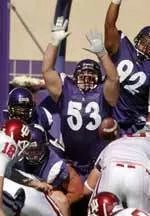 Trevor Schultz (53) attempts to block a kick in NU's overtime win over Indiana in 2004.