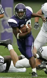Northwestern running back Tyrell Sutton, center, eludes Penn State defenders Jay Alford (13) Paul Posluszny (31) and Scott Paxson (41) as he gains yards during the first quarter, Saturday, Sept. 24, 2005, at Ryan Field in Evanston, Ill.