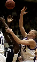 Bernard Cote and Penn State's Travis Parker battle for a rebound during the first half.
