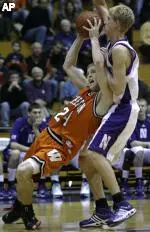 Kevin Coble, who scored 12 points to help Northwestern past Wheaton, defends Kent Raymond in the Wildcats' 41-39 win. (AP Photo/Nam Y. Huh)