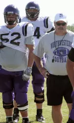 Offensive line coach Bret Ingalls (right), Joel Belding (#52) and Dylan Thiry.