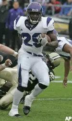 Northwestern running back Omar Conteh breaks the tackle of Purdue defensive end Cliff Avril on his way to score on an 11-yard-run run during the second quarter. (AP Photo/Michael Conroy)