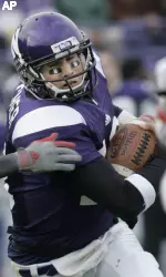 Northwestern quarterback C.J. Bacher carries the ball. (AP Photo/Charles Rex Arbogast)