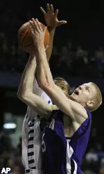 Jeff Ryan goes up for a shot as DePaul's Draelon Burns defends during the first half.