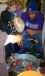Kim Thompson helps a friend bob for apples.