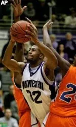 Northwestern's Sterling Williams (32) drive through Savannah State's Chris Linton and Lazarius Coleman on his way to the basket during the second half Saturday's game. (AP Photo/Brian Kersey)