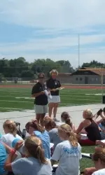 Assistant coaches Marti Kane and Jen Pelleriti talk field hockey with 50 athletes while waiting for the NU season to start on Aug. 25.