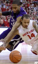 Sterling Williams and Ohio State's Jamar Butler dive for a loose ball during the first half. (AP Photo/Jay LaPrete)