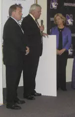 Mike Taylor and Dennis Grapenthin present a check for $10,000 to Tammy Walker, wife of former NU head coach Randy Walker.