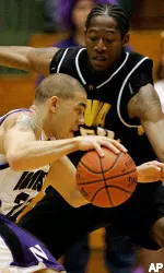 Michael Thompson drives on Iowa's Kurt Looby during the first half. (AP Photo/Brian Kersey)