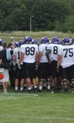 Northwestern huddles up during its fifth practice session at Camp Kenosha.