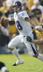 C.J. Bachér eludes Iowa's Mitch King during the first half. (AP Photo/Charlie Neibergall)