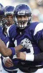 Mike Kafka celebrates his first-quarter TD with teammates. Kafka was forced to leave the game in the second quarter with a leg injury.