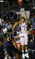 Northwestern's Drew Crawford (1) shoots over North Carolina A&T 's Nic Simpson for three of his 35 points as Northwestern defeated North Carolina A&T 90-65 in an NCAA college basketball game in Evanston, Ill., on Sunday, Dec. 13, 2009. (AP Photo/Charles Cherney)