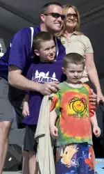 Pat Fitzgerald and sons Jack (in purple) and Ryan pose on stage at Clearwater Beach Day.