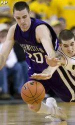 Craig Moore fights for a loose ball with Iowa's Jake Kelly during the second half.