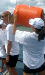Claire Pollard (left) in the instant before a celebratory cold shower from Stacey Lee and Lauren Lui.