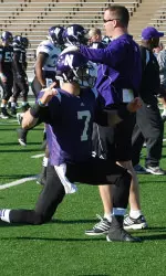 Pat Fitzgerald gives a pat on the helmet to QB Dan Persa during NU's dynamic warmup at Rice Stadium in Houston Tuesday.