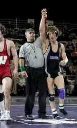 Sophomore Jason Welch (157) gets his hand raised after pinning Kalvin York to give the Wildcats a nine-point lead over Wisconsin.