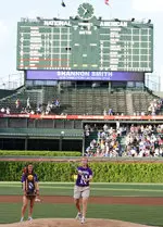 Shannon Smith fires a strike to home plate with her lacrosse stick before the Cubs-Astros game Tuesday night.
