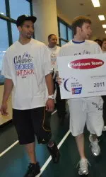 Drew Crawford and Alex Marcotullio lead the way for the men's basketball team during the Relay For Life walk at SPAC.