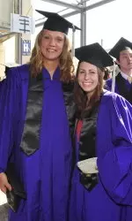 Maddi Rozwat of the women's cross counrty team (right) and women's basketball's Amy Jaeschke at commencement ceremonies Friday.