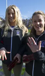 Caley Chelios (left) and Beatrice Conley show off the NCAA championship rings presented to them during the NU-Iowa football game Saturday at Ryan Field.
