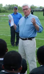 Pat Ryan, a member of Northwestern University's Board of Trustees and a former Wildcat football player, addresses the team following their scrimmage Saturday.