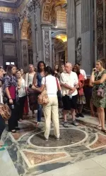 Learning about the Popes in the Basilica with our tour guide.