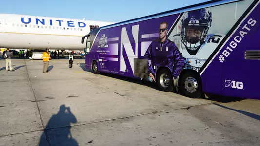 Pinstripe Bowl Arrival bus plane
