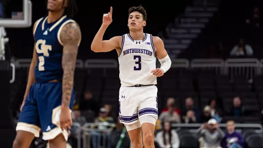 Northwestern guard Ty Berry points to the roof against Georgia Tech.