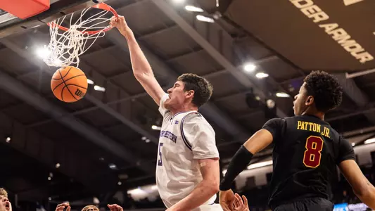 Northwestern's Keenan Fitzmorris throws down a dunk with one hand against USC.