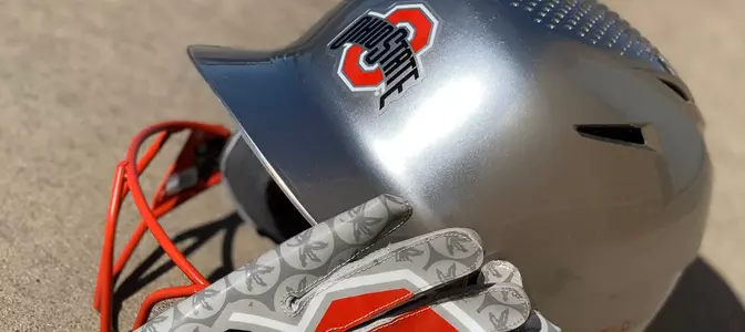helmet with softball glove ontop