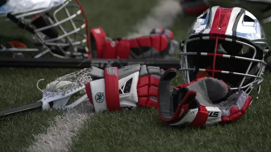 Lacrosse Gloves and Helmet On Field