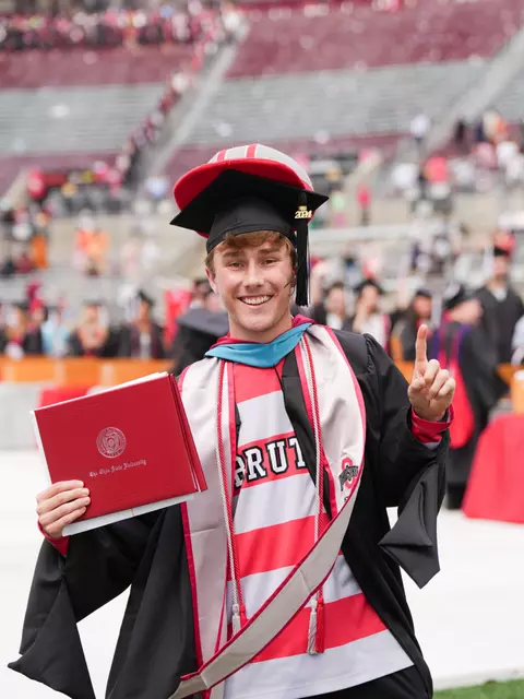 Graduation graduate holding his diploma