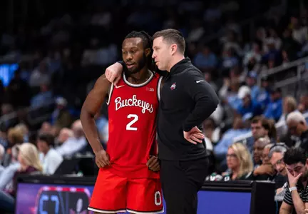 Bruce Thornton and Jake Diebler chat during the Ohio State vs. UCLA game on Dec. 16, 2023