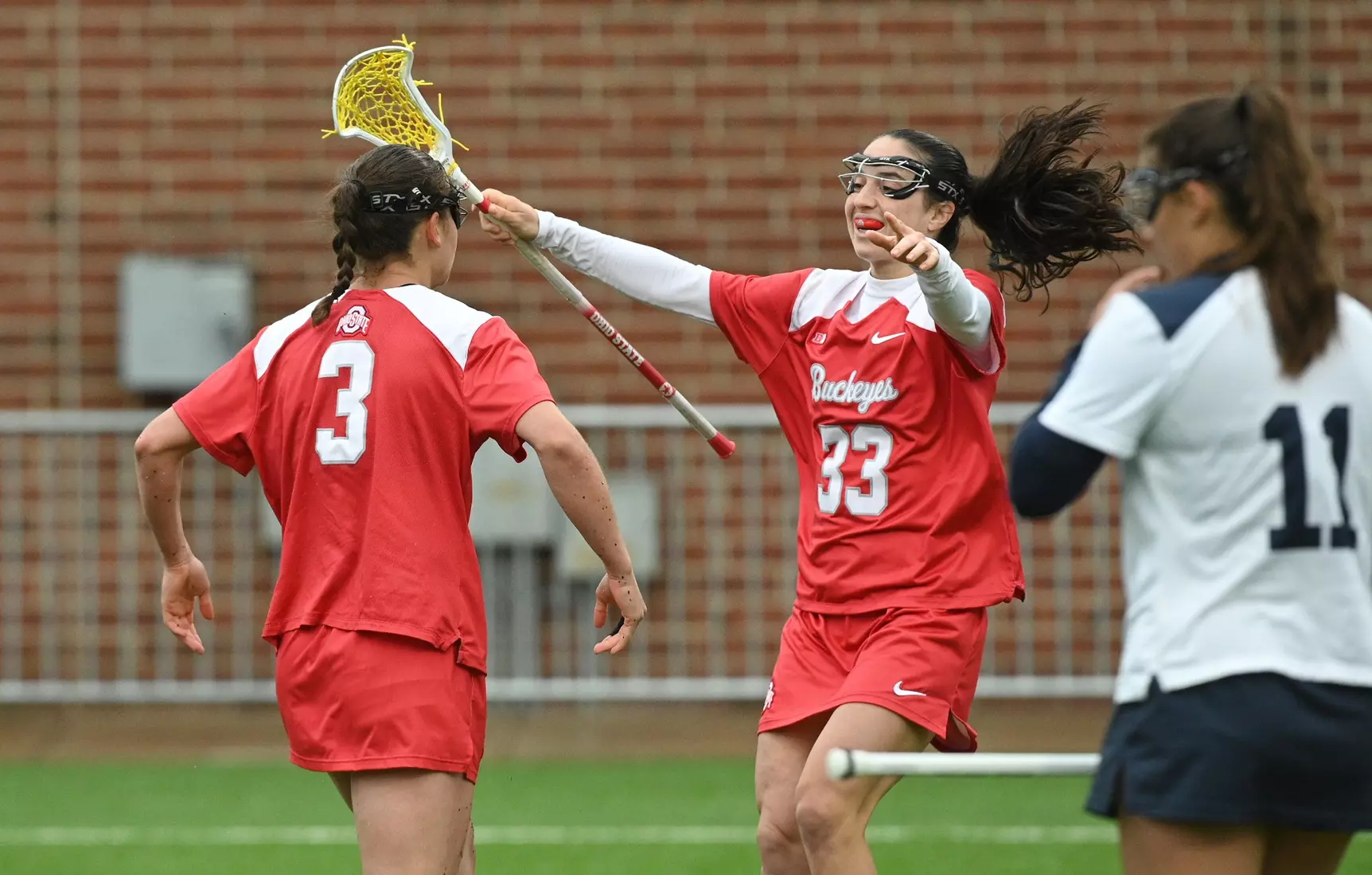 Ohio State's Annie Hargraves (3) celebrates her goal with Leah Sax (33) against Penn State during the 2024 Big Ten Women's Lacrosse Tournament quarterfinal game on April 27, 2024 in University Park, Pa. No. 7 seed Ohio State fell to No. 2 seed Penn State 13-15. Photo/Craig Houtz
