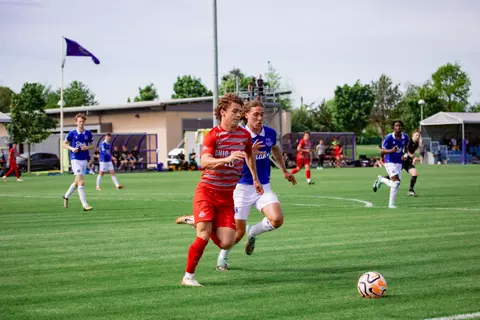 OSU Soccer Game in England vs Everton, Parker Grinstead runs with the ball against the other team's defender