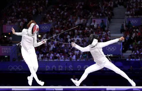 PARIS, FRANCE - AUGUST 01: Eleanor Harvey Team Canada (L) and Sera Azuma of Team Japan compete during the Women's Foil Team Bronze Medal Match Bout between Team Japan and Team Canada on day six of the Olympic Games Paris 2024 at Grand Palais on August 01, 2024 in Paris, France. (Photo by Clive Brunskill/Getty Images)