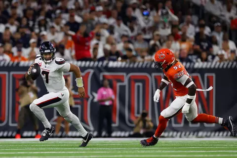 Houston Texans quarterback C.J. Stroud (7) rolls out to throw a pass under pressure from Chicago Bears defensive end Darrell Taylor (52) during an NFL football game, Sunday, Sept. 15, 2024, in Houston. (Aaron M. Sprecher via AP)