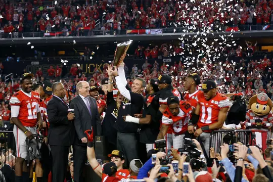 Ohio State Buckeyes head coach Urban Meyer holds up the National Championship trophy after beating Oregon Ducks 42-20 in College Football Playoff Championship game at AT&T Stadium in Arlington, Texas on January 12, 2015. (Dispatch photo by Kyle Robertson)