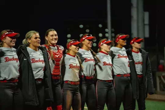 Softball players singing Carmen post game