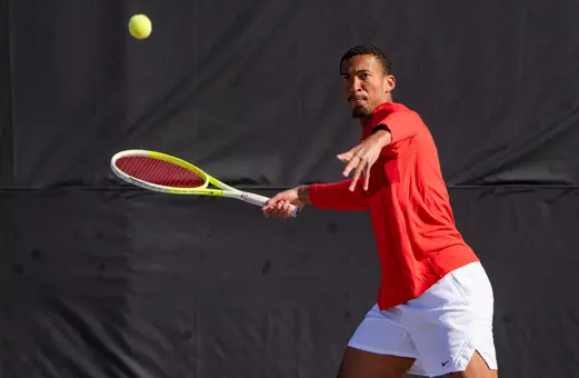 Alex Okonkwo hitting a forehand shot on the outdoor courts.