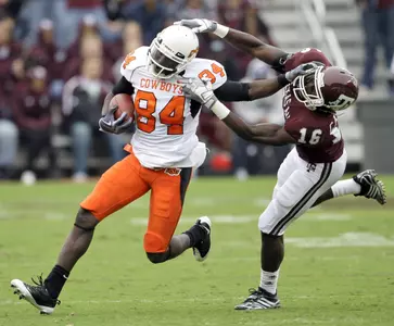 Texas A&M cornerback Steven Campbell (16) tries to tackle Oklahoma State wide receiver Hubert Anyiam (84). (AP)