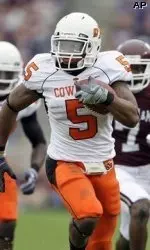 Oklahoma State running back Keith Toston (5) rushes for a first down as Texas A&M cornerback Terrence Frederick (7) chases him during the first quarter.