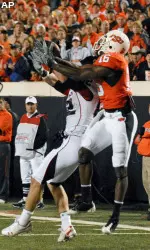 OKlahoma State cornerback Perrish Cox intercepts a pass in the first half.