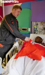 Brandon Weeden visits with a patient at the Texas Scottish Rite Hospital For Children.